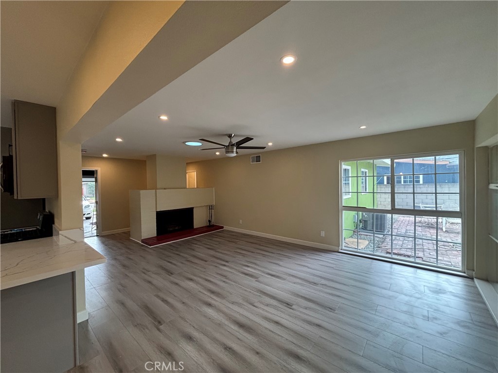 1022 Concord Street Santa Ana, CA 92701 - Photo 6 of 19 an empty room with wooden floor fireplace and windows