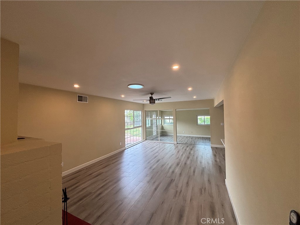 1022 Concord Street Santa Ana, CA 92701 - Photo 7 of 19 a view of an empty room with wooden floor and a window