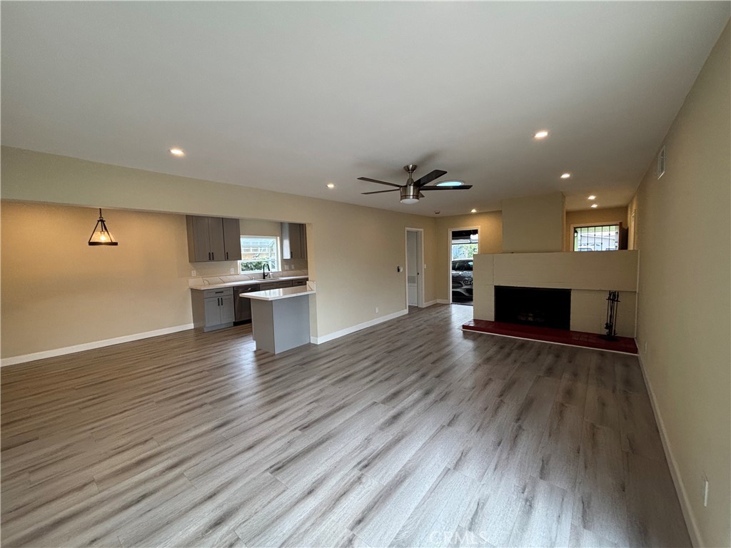 1022 Concord Street Santa Ana, CA 92701 - Photo 8 of 19 an empty room with wooden floor fireplace and windows