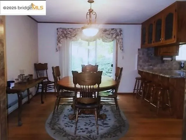 a view of a dining room with furniture and chandelier
