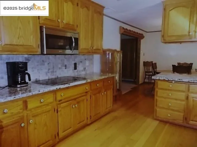 a kitchen with sink a microwave and cabinets