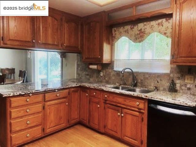 18215 Aarondale Road Sonora, CA 95370 - Photo 32 of 39 a kitchen with granite countertop wooden cabinets a sink and dishwasher