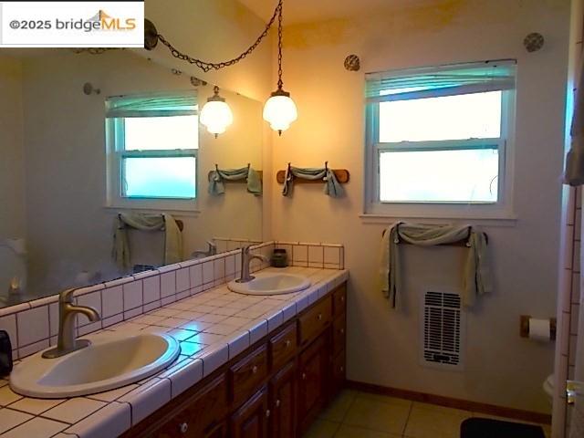 18215 Aarondale Road Sonora, CA 95370 - Photo 36 of 39 a bathroom with a granite countertop sink a mirror and a window