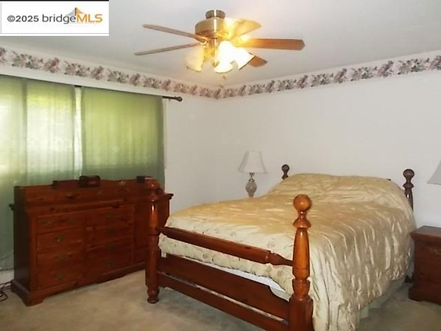 18215 Aarondale Road Sonora, CA 95370 - Photo 37 of 39 a bedroom with a bed and a chandelier