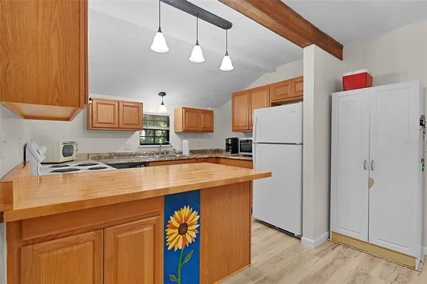 a kitchen with stainless steel appliances granite countertop a refrigerator a sink and a stove