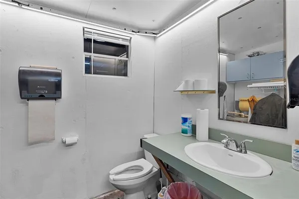 an aerial view of a house with table and chairs under an umbrella