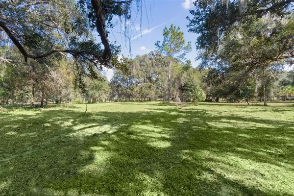 a yard with swimming pool and green space
