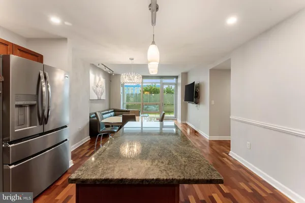 a kitchen with sink and refrigerator
