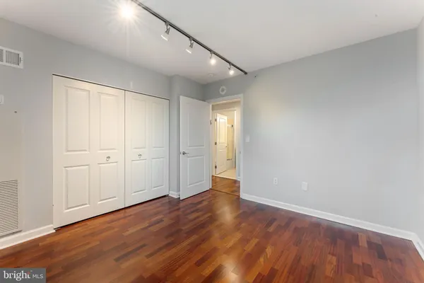 a view of an empty room with wooden floor