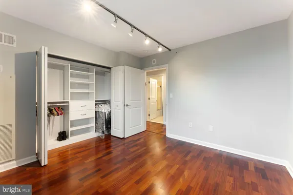 a view of empty room with wooden floor