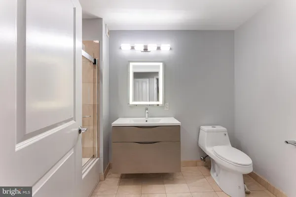 a bathroom with a sink toilet and mirror