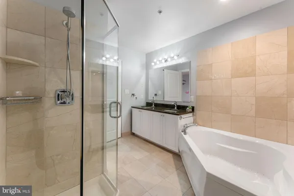 a bathroom with a bathtub and a shower
