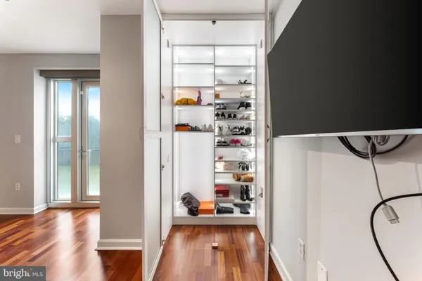a view of a hallway to a livingroom with furniture