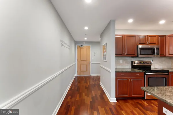 a view of a kitchen with a sink wooden floor and cabinets
