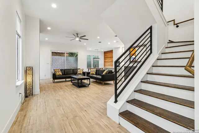 a view of a hallway with wooden floor and entryway