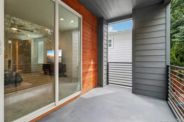 a view of a roof deck with table and chairs and wooden floor