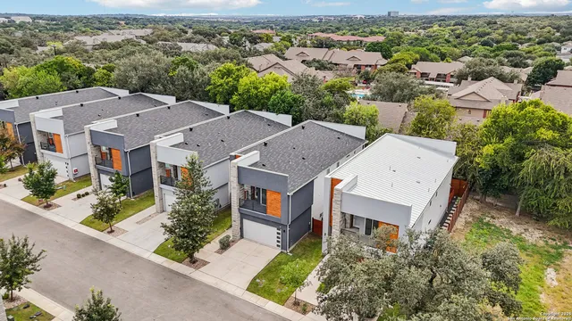 an aerial view of residential houses with outdoor space