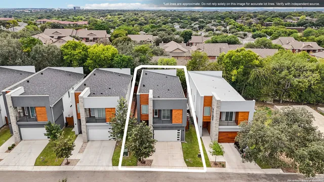 an aerial view of a house with a yard