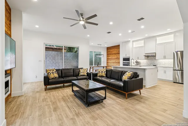 a living room with furniture and kitchen view