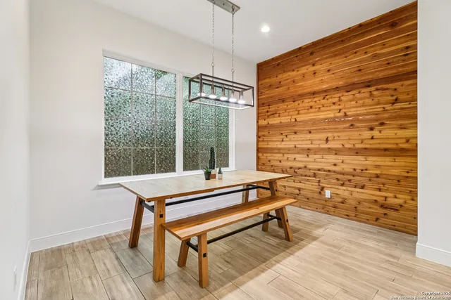 a sitting area with pool table and windows