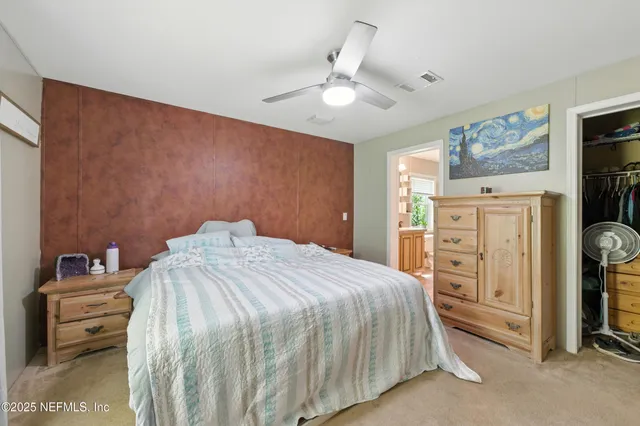 a bedroom with a bed and a view of bedroom