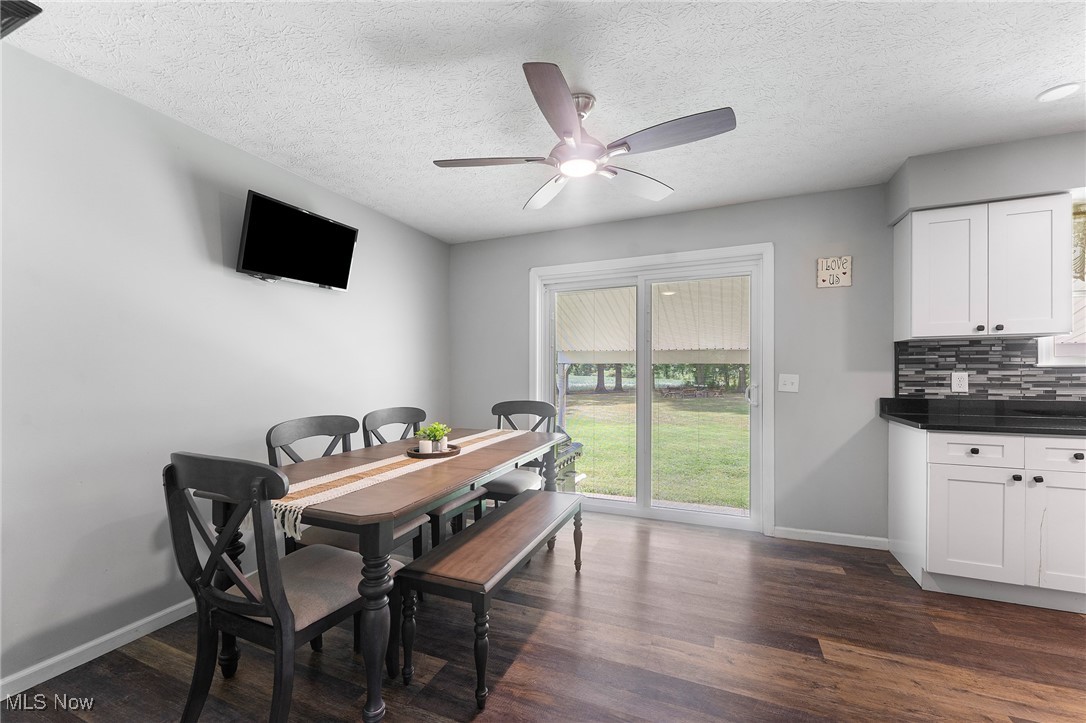 1761 Rustic Run Road Warren, OH 44481 - Photo 21 of 45 Dining area featuring dark wood finished floors, a textured ceiling, and ceiling fan