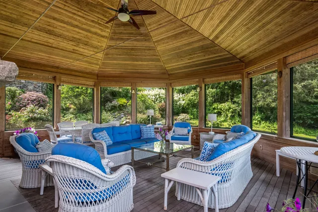 a roof deck with a dining table and chairs with wooden floor