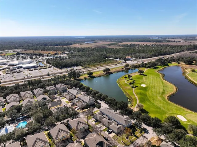 an outdoor sitting area with swimming pool and furniture