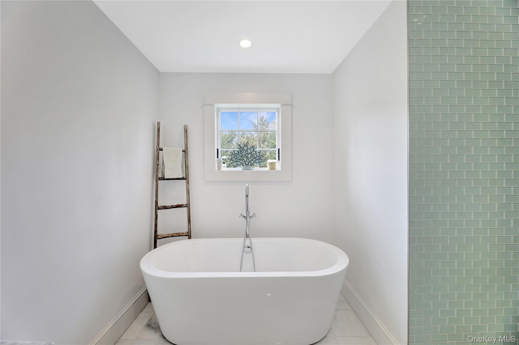 198 South Country Road Remsenburg, NY 11960 - Photo 24 of 49 a white bath tub sitting in a bathroom