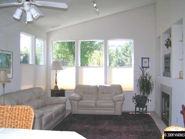 899 Caughlin Glen Reno, NV 89519 - Photo 3 of 9 a living room with furniture a large window and a fireplace