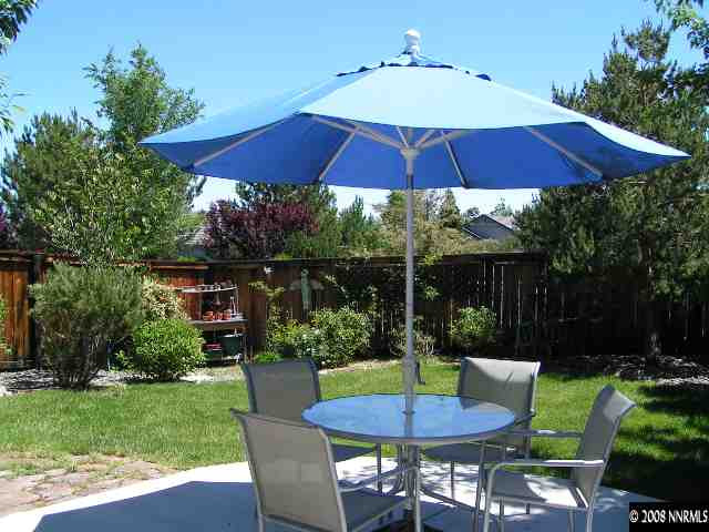899 Caughlin Glen Reno, NV 89519 - Photo 7 of 9 a view of patio with chairs and table under an umbrella