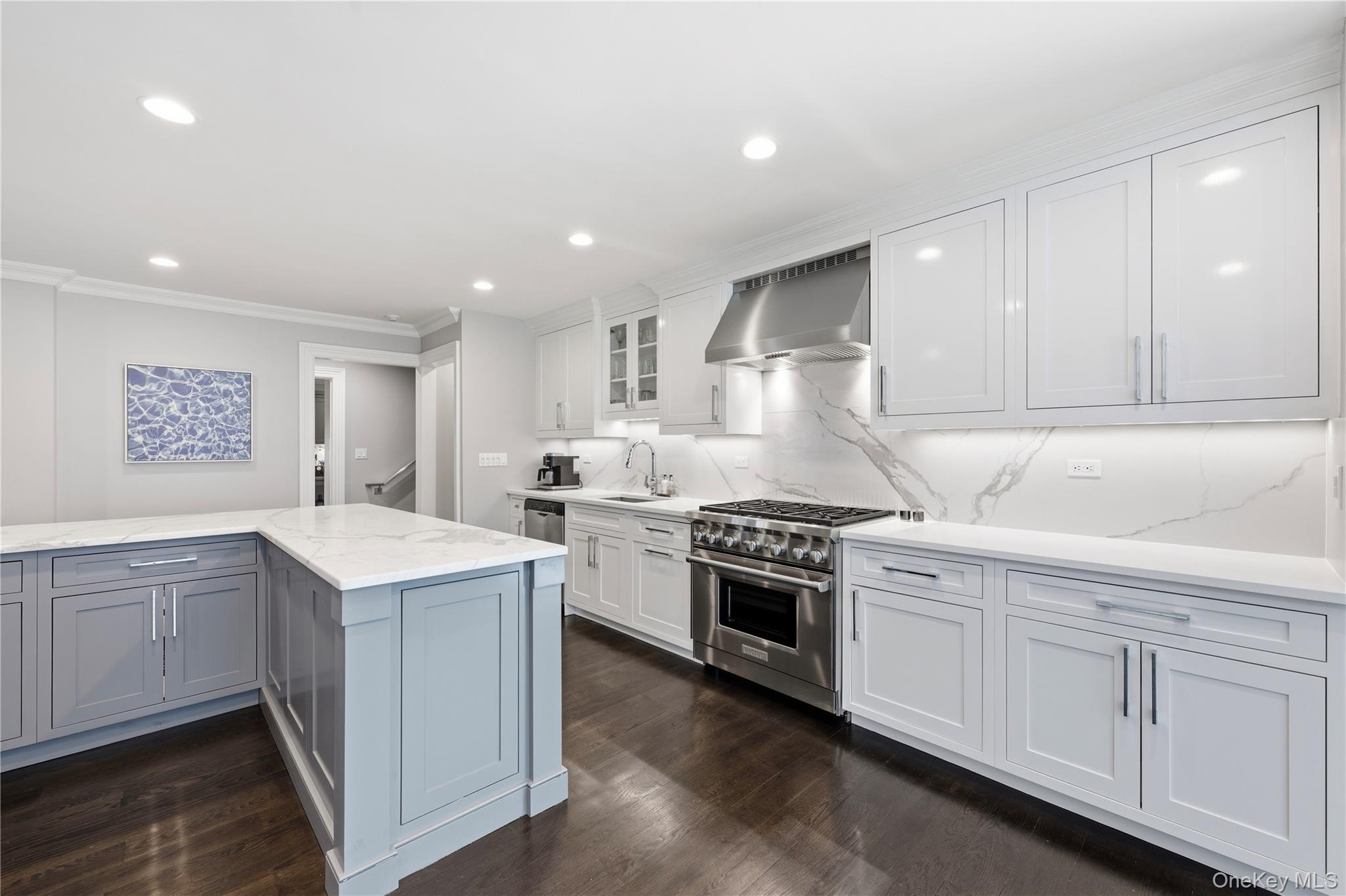 11 Thornewood Road Armonk, NY 10504 - Photo 14 of 35 a kitchen with white cabinets appliances and wooden floor