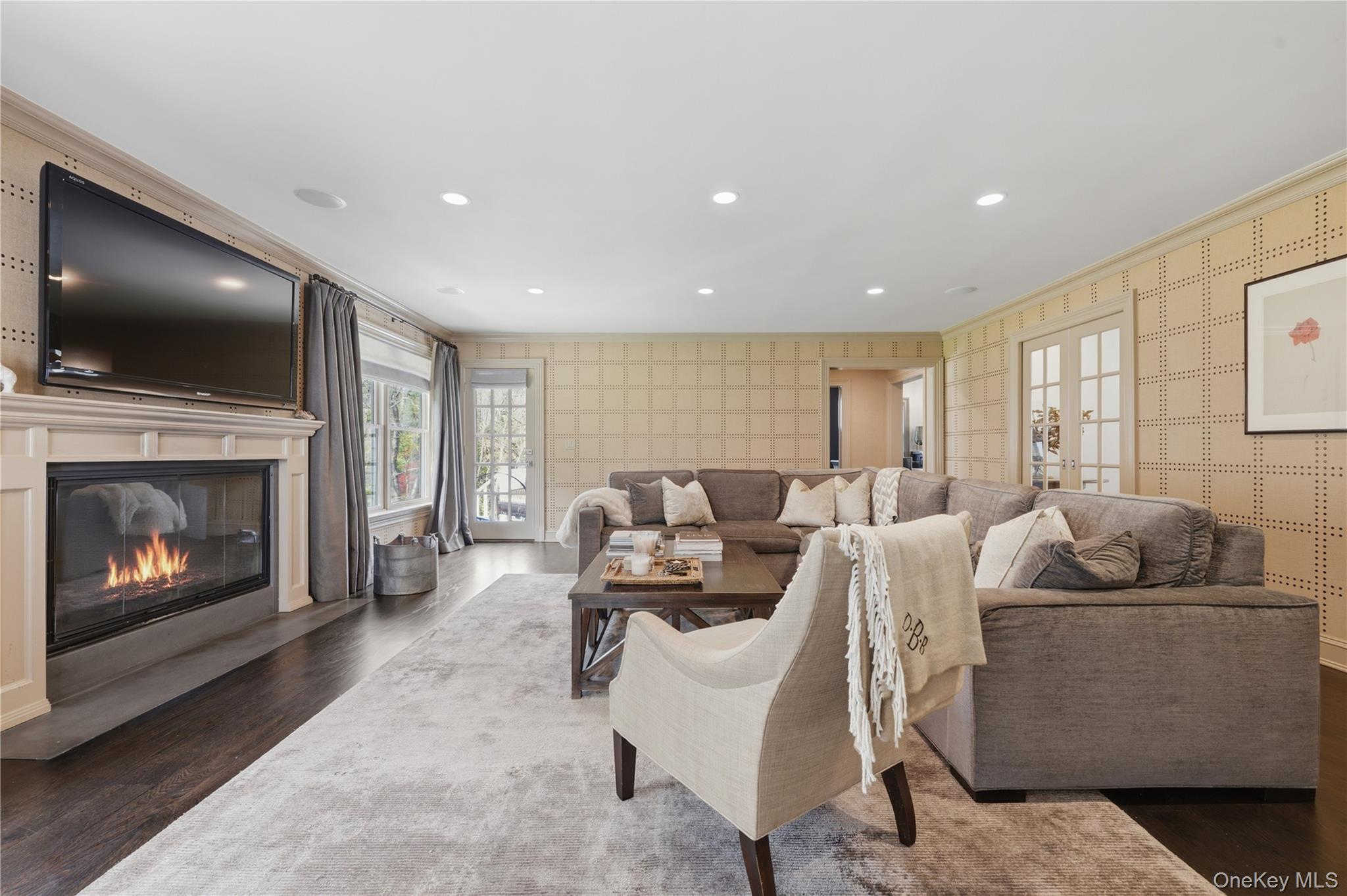 11 Thornewood Road Armonk, NY 10504 - Photo 16 of 35 a living room with furniture a flat screen tv and a fireplace