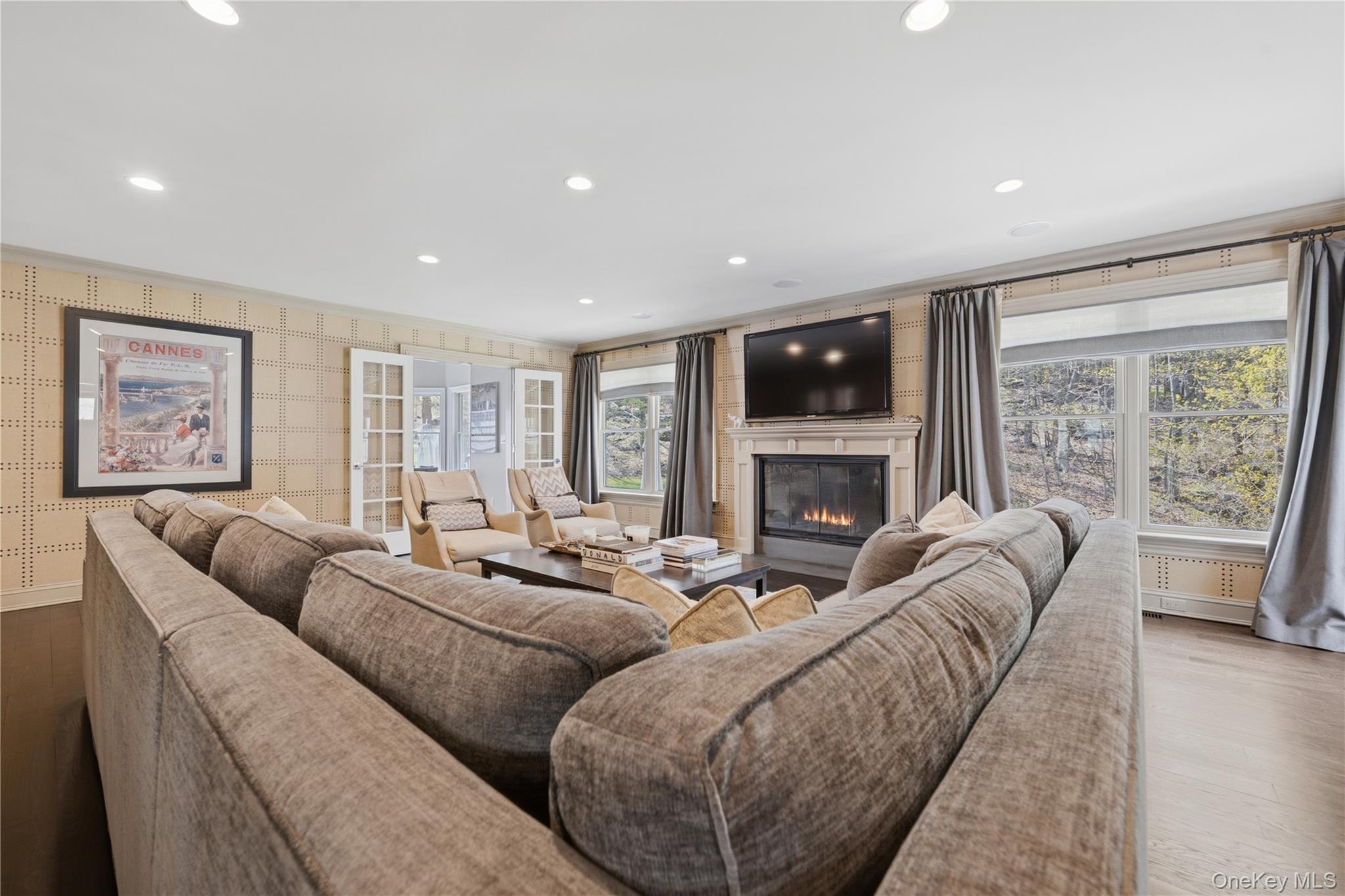 11 Thornewood Road Armonk, NY 10504 - Photo 17 of 35 a living room with furniture two large window and a fireplace
