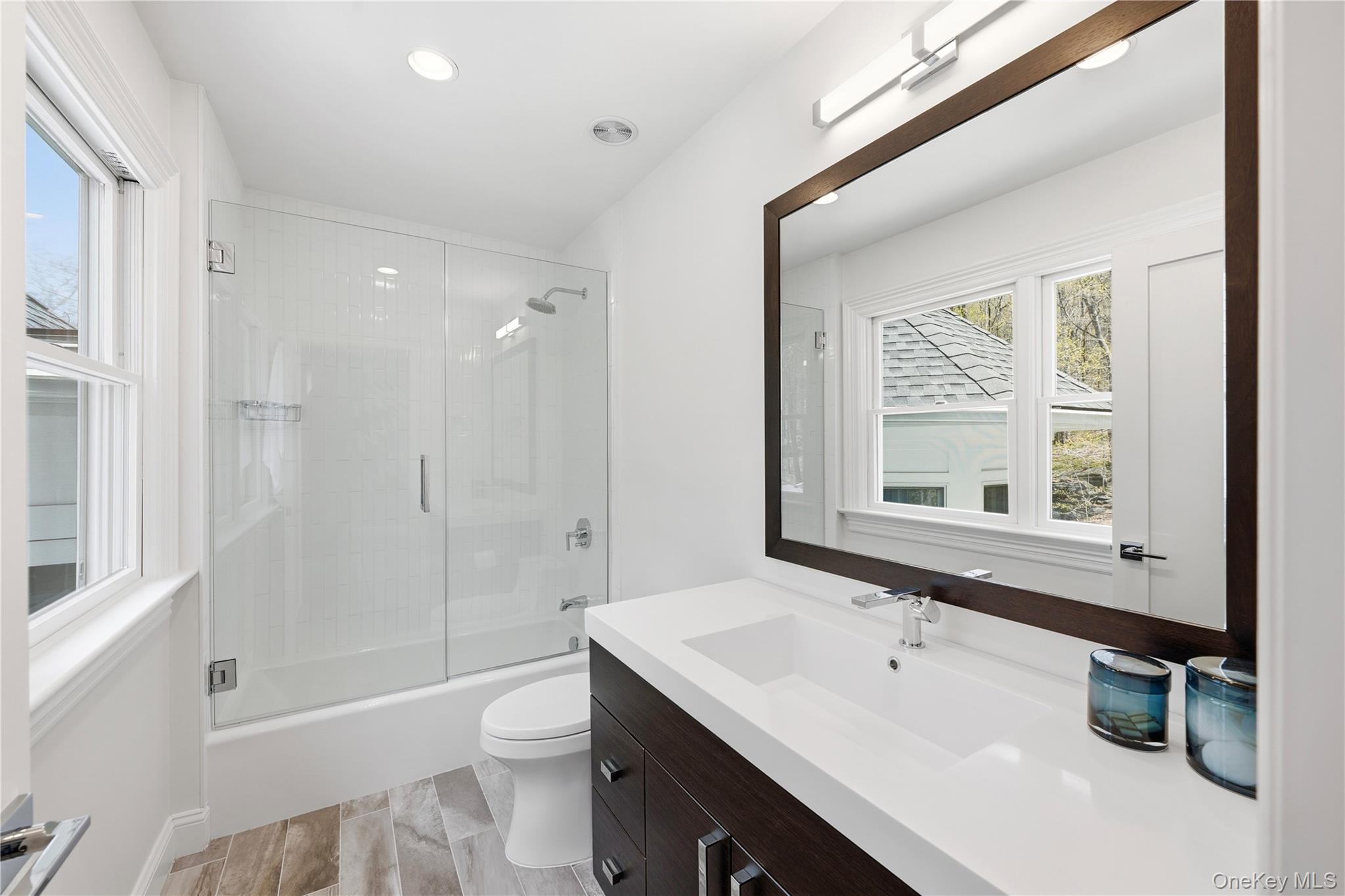 11 Thornewood Road Armonk, NY 10504 - Photo 20 of 35 a bathroom with a sink a toilet a mirror and a tub
