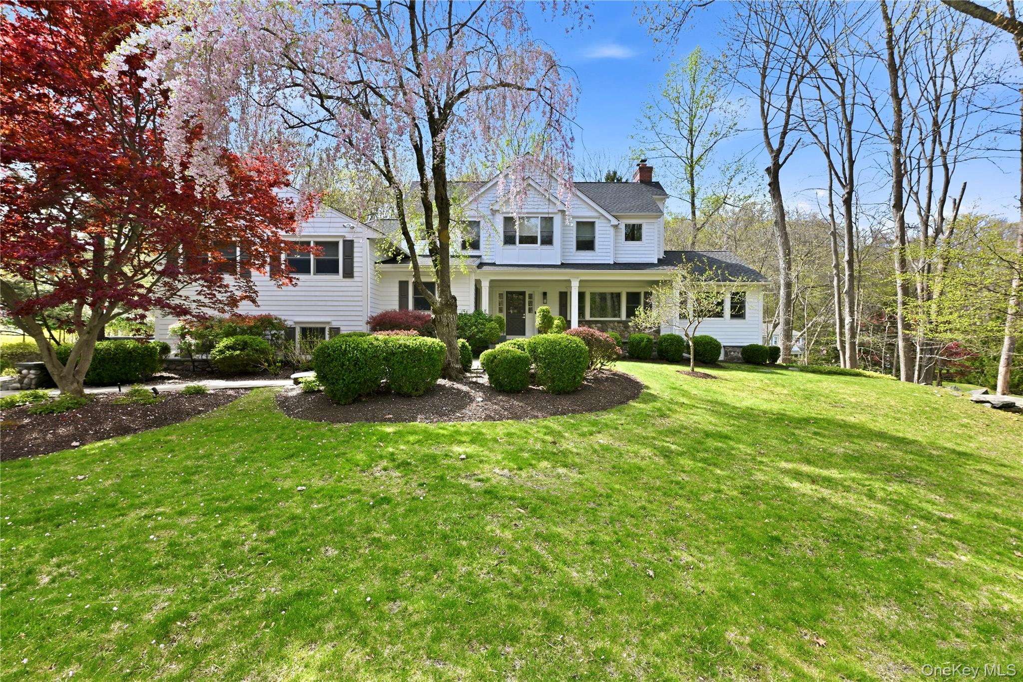 11 Thornewood Road Armonk, NY 10504 - Photo 2 of 35 a front view of a house with garden and trees