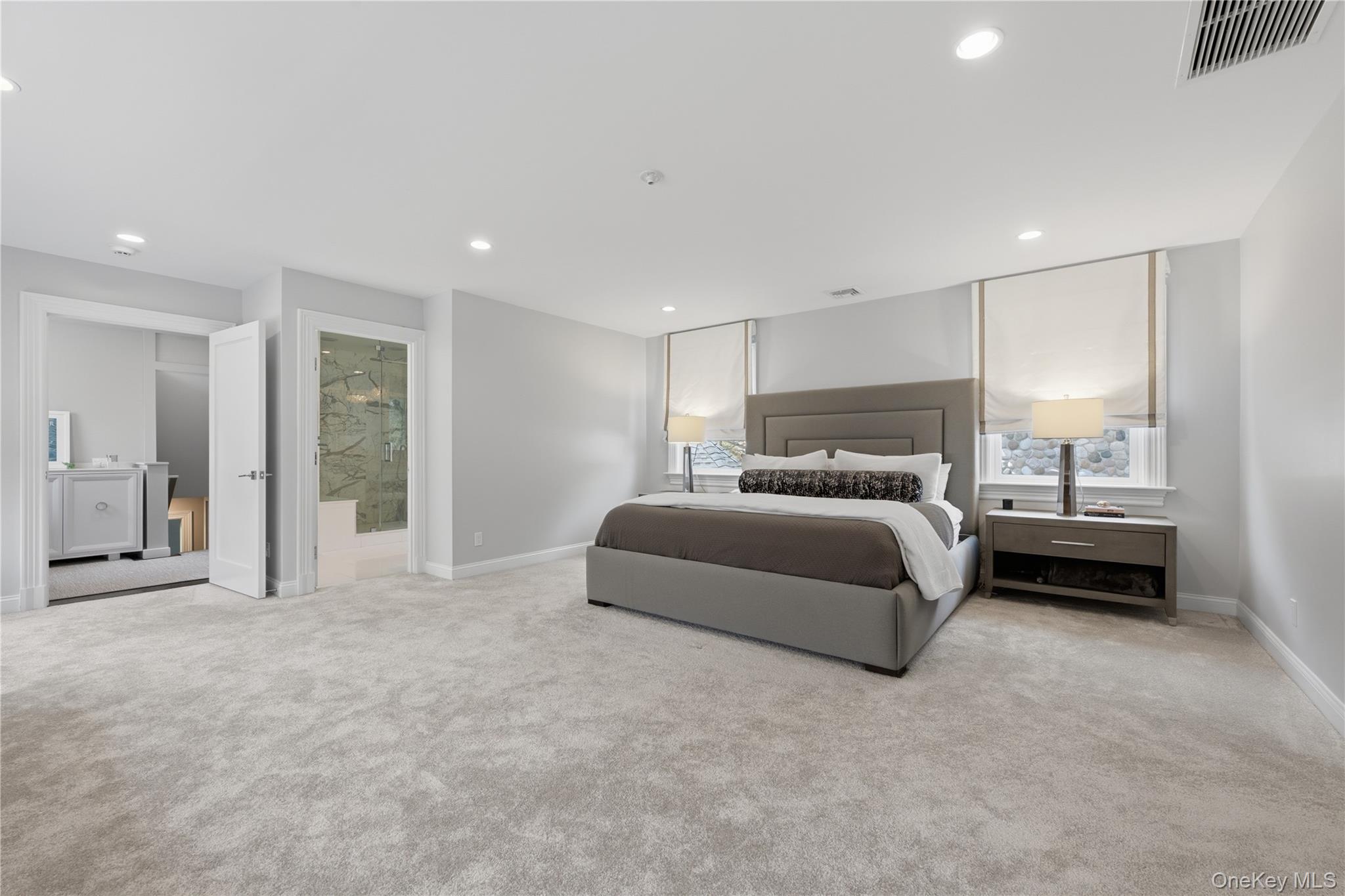 11 Thornewood Road Armonk, NY 10504 - Photo 25 of 35 a spacious bedroom with a bed and a large window