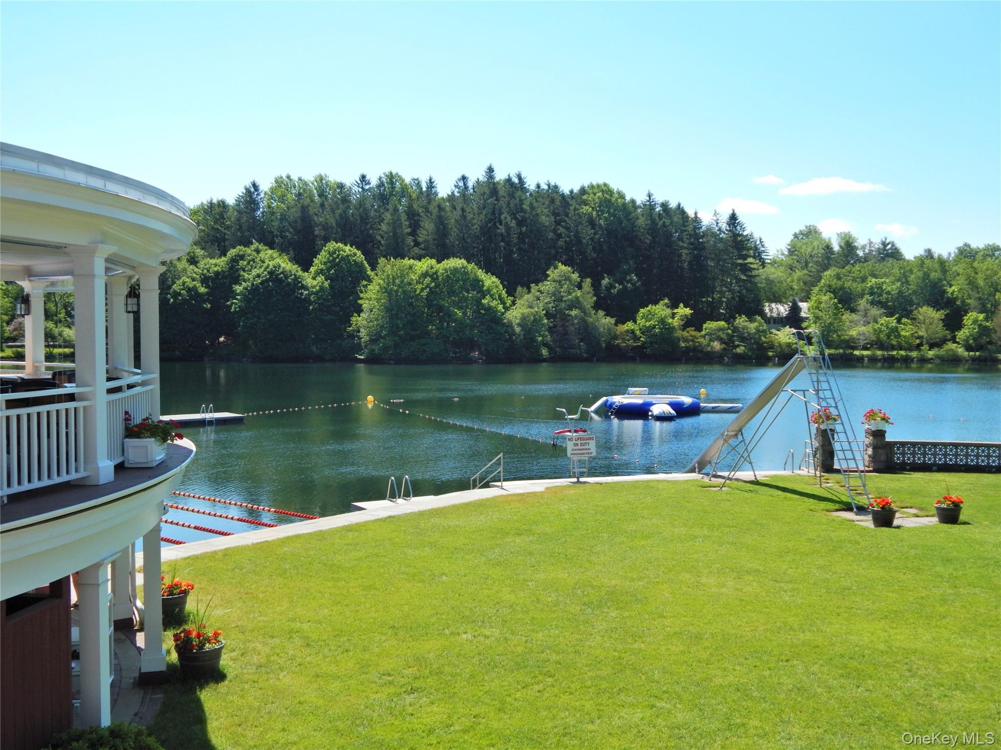11 Thornewood Road Armonk, NY 10504 - Photo 33 of 35 a view of a lake with a yard and large trees