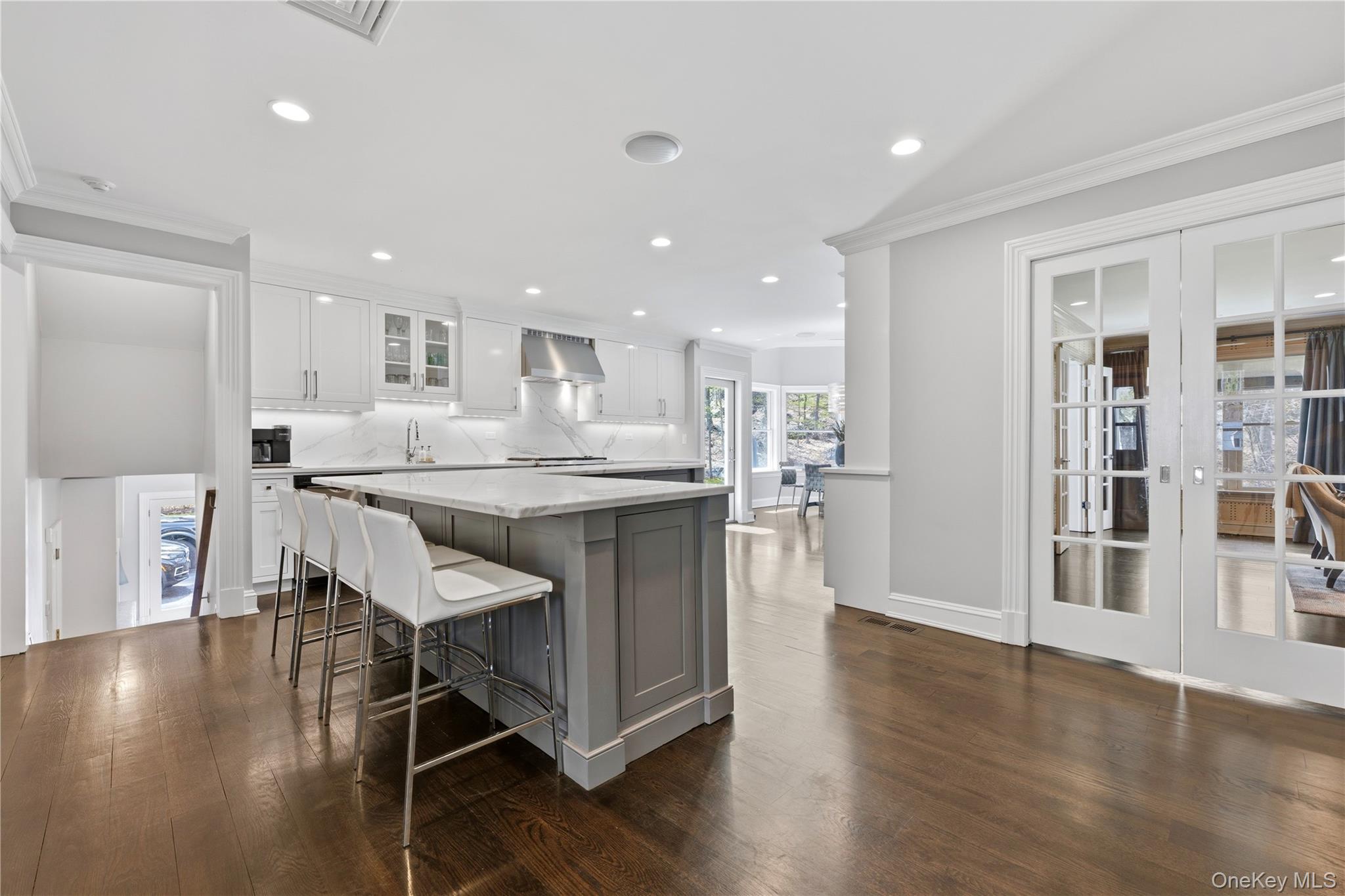 11 Thornewood Road Armonk, NY 10504 - Photo 10 of 35 a kitchen with stainless steel appliances granite countertop a stove a sink dishwasher and a refrigerator with wooden floor