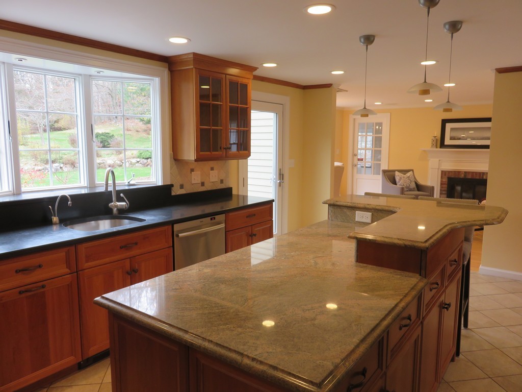17 Juniper Road Weston, MA 02493 - Photo 9 of 30 a kitchen with stainless steel appliances granite countertop a sink a stove and a refrigerator