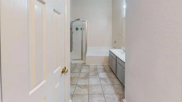 a bathroom with a bathtub and shower