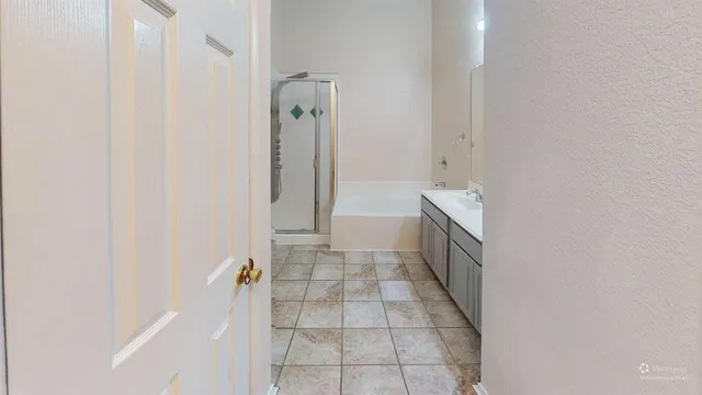 a bathroom with a bathtub and shower