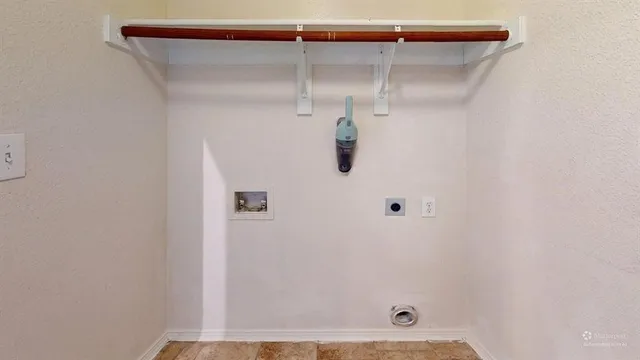 an empty room with wooden floor chandelier fan and windows