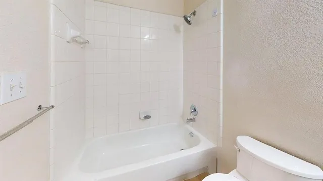 a large kitchen with cabinets and stainless steel appliances