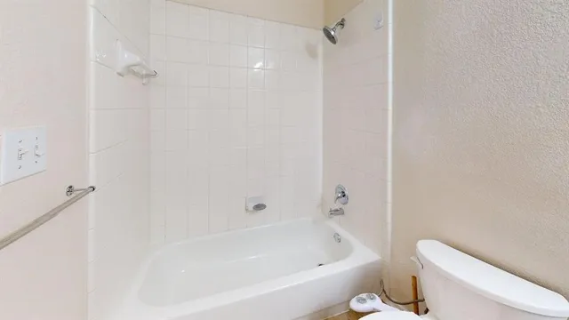 a bathroom with a bathtub and toilet
