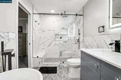 a bathroom with a sink toilet tub and shower