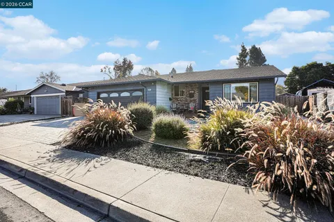 a front view of house with yard and mountain view in back