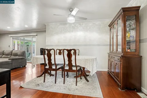 a view of a livingroom with furniture a fireplace a chandelier and wooden floor