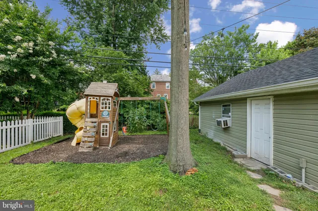 a view of a chair and table in backyard of the house