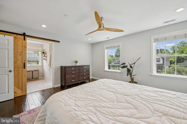 a bedroom with a bed and a large window